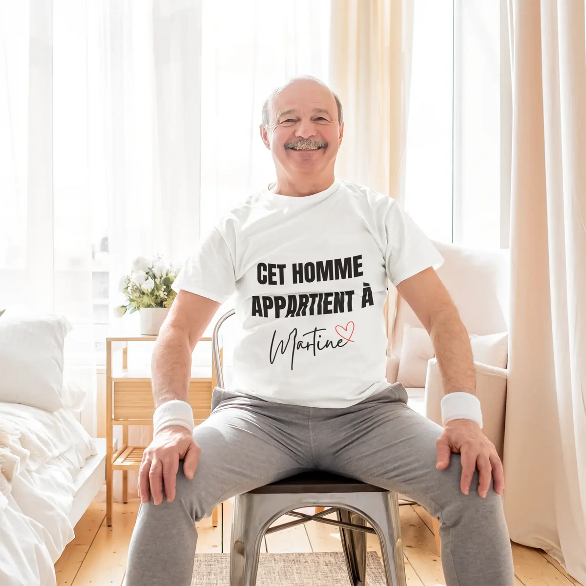 rounded-neck-tee-mockup-of-a-smiling-senior-man-sitting-on-a-chair-at-home-m17555-r-el2